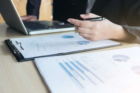 Teamwork of business two colleagues analysis with financial data and marketing report graph, Young co worker discussing and brainstorm new idea for start up project plan, Partner meetings and briefingの写真素材