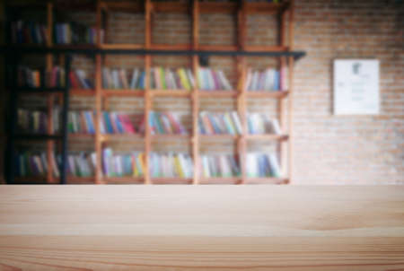 Empty wooden table and blur background of abstract in front of modern library or knowledge source can be used Mock up for display of product or for montage.の写真素材
