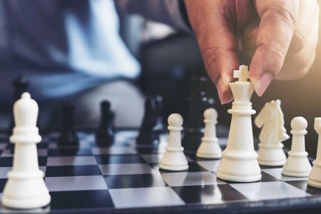 Close up of hands confident businessman colleagues playing chess game to development analysis new...