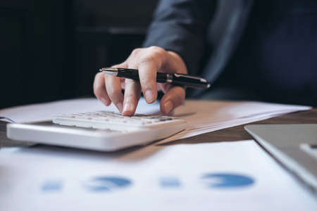 Professional business woman working with calculator, Doing finance on laptop, document graph and...