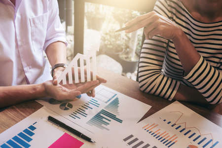 Business team two executive colleagues discussing and analysis working Financial investment on calculator with calculate on tablet Analyze business and market growth on financial document data graph.の写真素材