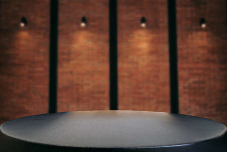 Empty wooden table and blur background of abstract in front of wall texture or old brick wall can be used Mock up for display of product or for montage.の写真素材