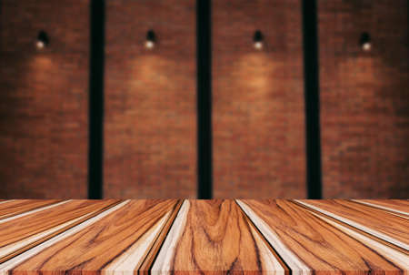 Empty wooden table and blur background of abstract in front of wall texture or old brick wall can be used Mock up for display of product or for montage.の写真素材