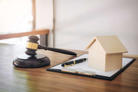 Gavel on sounding block at courtroom for decide home insurance, Law and justice concept, Settle a house dealing lawsuit.