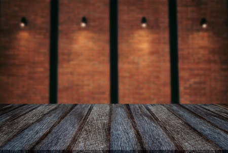 Empty wooden table and blur background of abstract in front of wall texture or old brick wall can be used Mock up for display of product or for montage.の写真素材