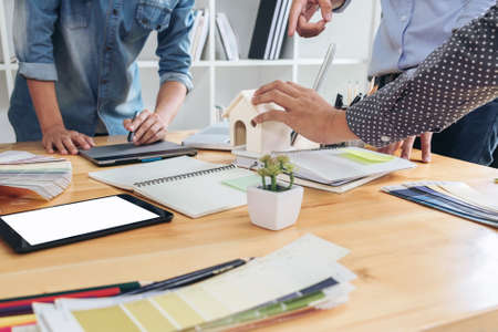 Young colleagues designers working together on a creative project and color samples for selection, Color swatch samples, Brainstorming Planning Partnership, creative graphic design working desktop.の写真素材