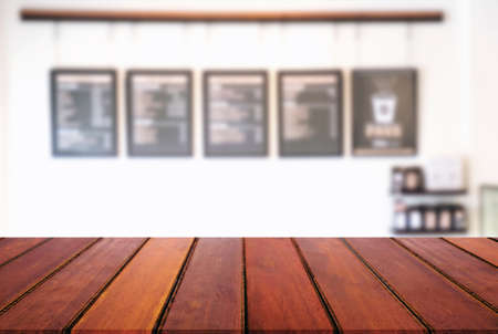 Empty wooden table and blur background of abstract in front of restaurant or coffee shop, cafe  can be used Mock up for display of product or for montage.の写真素材