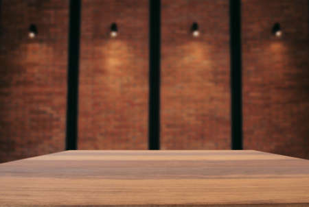 Empty wooden table and blur background of abstract in front of wall texture or old brick wall can be used Mock up for display of product or for montage.の写真素材