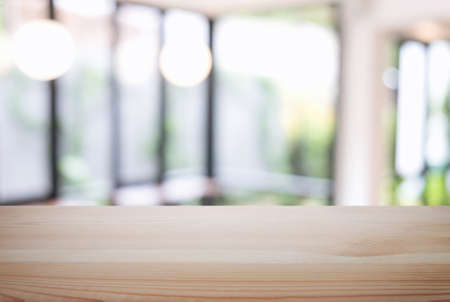 Empty wooden table and blur background of abstract in front of restaurant or coffee shop, cafe  can...