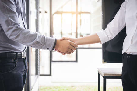 Two businesspeople shaking hands during a meeting in the office, success, dealing, greeting &...