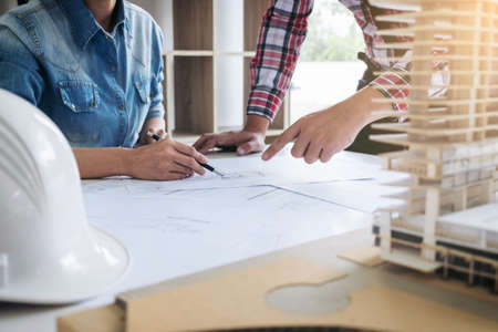 Architect working on blueprint, Engineer meeting working with partner colleagues and engineering...