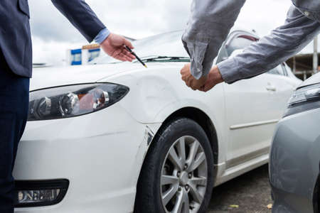 Insurance Agent examine Damaged Car and filing Report Claim Form after accident, Traffic Accident...