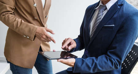 Confident business woman leader, business team meeting conference in office, The senior executive is standing working with Secretary.の写真素材