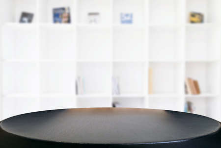 Empty wooden table and blur background of abstract in front of modern library or knowledge source can be used Mock up for display of product or for montage.の写真素材