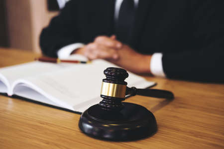 Judge gavel with Justice lawyers, Businessman in suit or lawyer working on a documents. Legal law, advice and justice concept.の写真素材