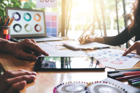 Two young dressmaker or designer colleagues working and discussing fashion project designers and drawing sketches for clothes, profession and job occupation, Fashion Designer Stylish Concept.の写真素材