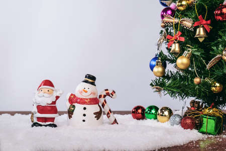 Christmas decoration Holiday or new year with Santa Claus and snowman on snow background and copy space.の写真素材