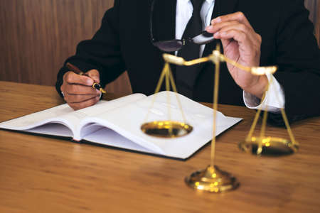 Judge gavel with Justice lawyers, Businessman in suit or lawyer working on a documents. Legal law, advice and justice concept.の写真素材