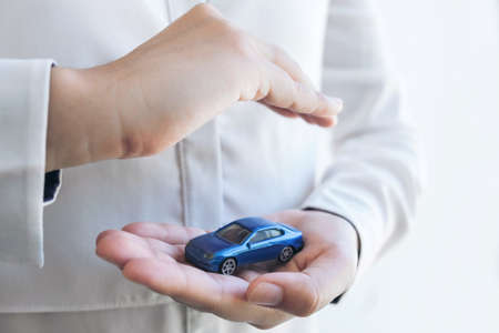 insurance and care protection of car concept, woman with protective gesture of blue car.の写真素材