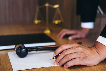 Judge gavel with Justice lawyers, Businessman in suit or lawyer working on a documents. Legal law, advice and justice concept.の写真素材