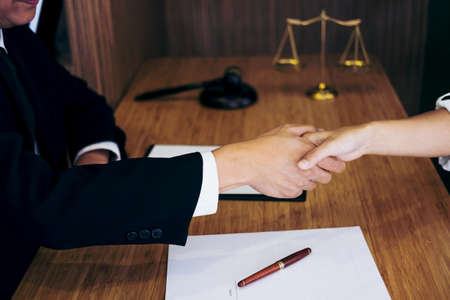 Handshake after good cooperation, Consultation between a male lawyer and businessman customer, tax and the company of real estate concept.の写真素材