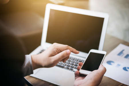 Professional business man working with smartphone, Doing finance on laptop and analysis business...