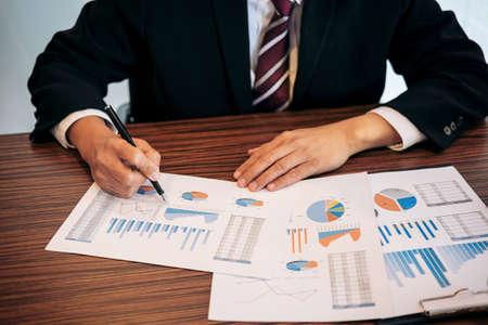 Business Financing Accounting Banking Concept, businessman doing finances and calculate about cost to real estate investment and in other, tax system.の写真素材