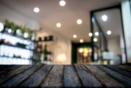 Empty wooden table and blurred background of abstract in front of restaurant or coffee shop for display of product or for montage.の写真素材