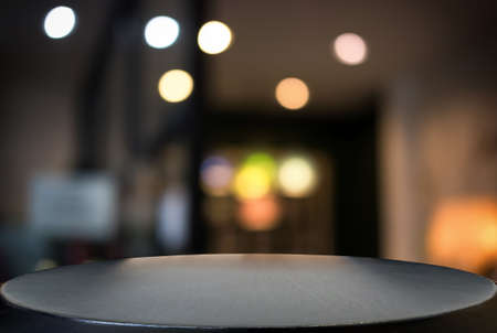Empty wooden table and blurred background of abstract in front of restaurant or coffee shop for display of product or for montage.の写真素材