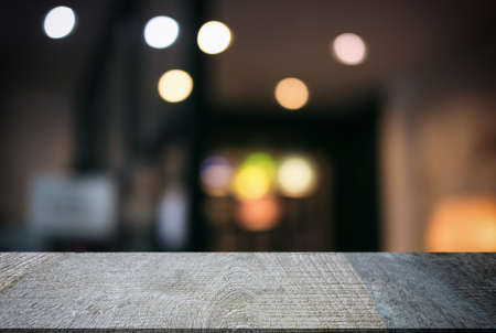 Empty wooden table and blurred background of abstract in front of restaurant or coffee shop for...