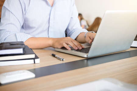 Professional businessman working at workplace, Doing finance on laptop, document graph and analysis business strategy to development profit.の写真素材