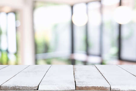 Empty wooden table and blurred background of abstract in front of restaurant or coffee shop for...