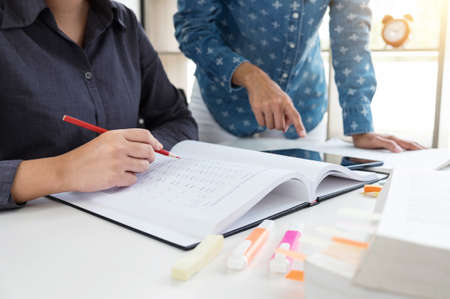 Images of Disappointed, Young students campus or classmates helps friend catching up workbook and...
