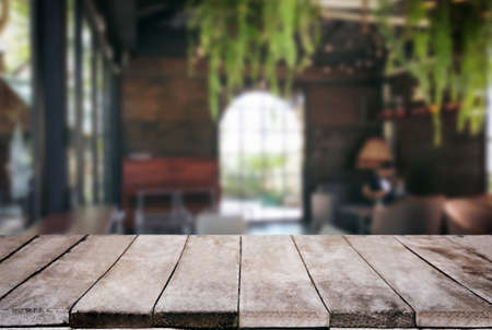 Empty wooden table and blurred background of abstract in front of restaurant or coffee shop for display of product or for montage.の写真素材