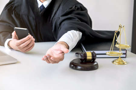 Image of Male lawyer or judge importune bribes client, working with phone and Law books, report the...