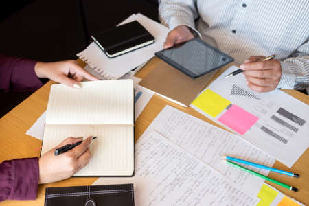 Education, teaching, learning, technology and people concept. Two high school students or classmates...