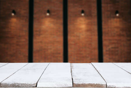 Selected focus empty wooden table and wall texture or old brick wall blur background image. for your...