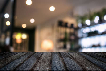 Empty wooden table and blurred background of abstract in front of restaurant or coffee shop for display of product or for montage.の写真素材