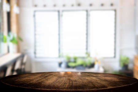 Empty wooden table and blurred background of abstract in front of restaurant or coffee shop for display of product or for montage.の写真素材