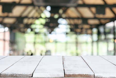 Selected focus Empty wooden table and blurred background of abstract in front of coffee shop or restaurant for display of product or for montage.の写真素材