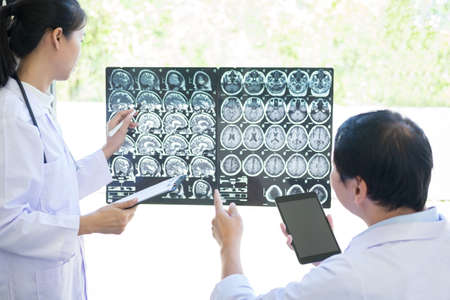 Professor Doctor discussing and consulting method with patient treatment results on brain x-ray film...