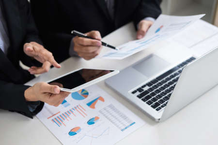 Coworking process, young business managers crew working new startup project with document graph,...