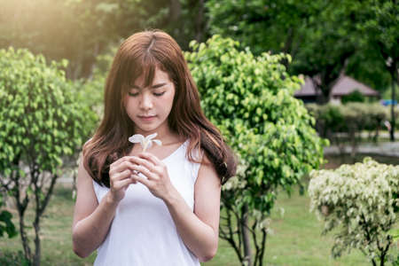 Young smiling asian girl relax in the park on holiday.の写真素材