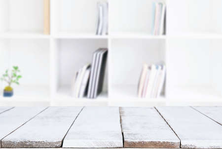 Selected focus empty old wooden table and Library or Bookstore blur background with bokeh image. for your photomontage or product display.の写真素材