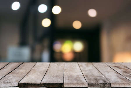 Empty wooden table and blurred background of abstract in front of restaurant or coffee shop for display of product or for montage.の写真素材