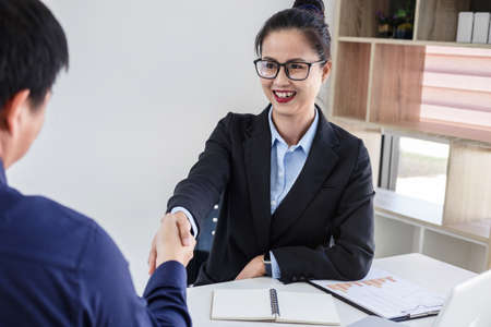 Finishing up a meeting, Business handshake after discussing good deal of Trading contract for both companies and gesturing people connection deal, Meeting and greeting concept.の写真素材