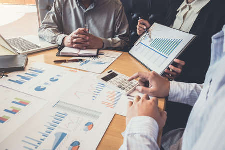 Meeting and greeting, Business team colleagues discussing working analysis with financial data and marketing growth report graph in team, Meeting Talking Brainstorming Communication Concept.の写真素材