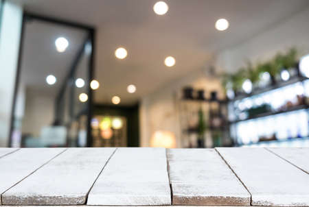 Empty wooden table and blurred background of abstract in front of restaurant or coffee shop for display of product or for montage.の写真素材