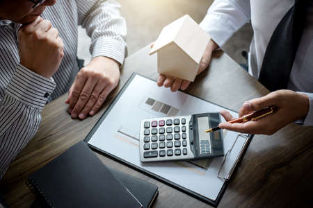 Real estate broker agent being analysis and making the decision a home estate loan to customer,...