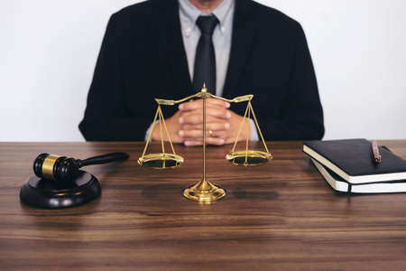 Judge gavel with scales of justice, male lawyers working having at law firm in office. Concepts of law.の写真素材